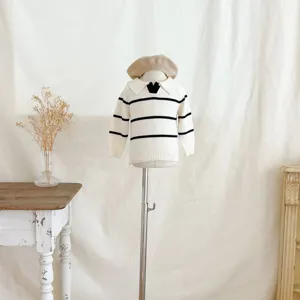 Detail view of infants striped knit sweater with lapel collar and cute beige beret styling.