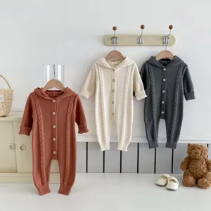 Detailed view of cute baby knitted hooded romper in autumn, comfortable cotton fabric for infants.