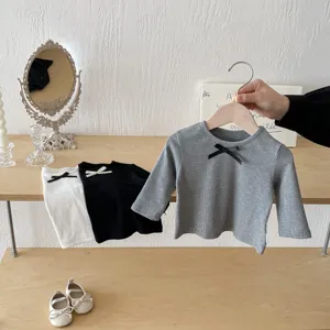 Detailed shot of kids long-sleeve ribbed t-shirt with cute bow detail, casual toddler clothing.