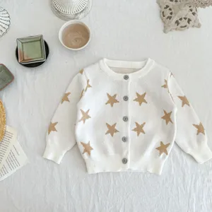 Detailed view of the cozy white knitted baby cardigan featuring gold star patterns and front buttons.