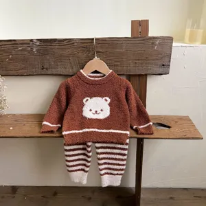 Detailed view of cute baby autumn winter soft fleece home clothing set with bear and stripes.