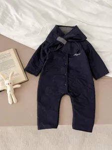 Detailed view of dark blue quilted baby winter romper featuring warm fleece lining and cozy design.