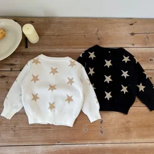 Infant baby knit cardigan sweater with gold star pattern, detailed view of texture and knit quality.