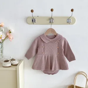 Close-up detail of cute baby girl knitted romper featuring delicate ruffles and collar.