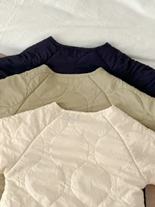 Infant quilted rompers detail view showing soft padding texture and round collar design options.