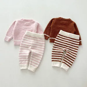 Fluffy fleece baby loungewear set detail, soft thermal long-sleeve top and cozy striped pants.