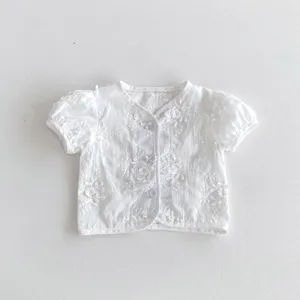 Infant baby white embroidered short sleeve cardigan detail, delicate floral cutwork style.