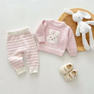 Detail shot of cute baby plush bunny sweater, striped pants and shoes set, soft and warm.