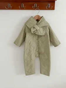 Detailed view of baby winter quilted romper in light green with cute plush collar design.