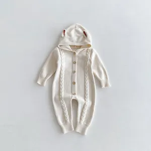Charming knit baby romper with adorable hood ears and cable pattern details. Soft and cozy.