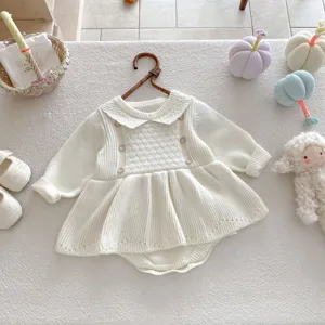 Cute baby girl knitted romper dress with long sleeves and ruffles, cozy autumn style detail view.