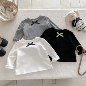 Girls long sleeve t-shirt detail showing cute bow and soft ribbed fabric texture design.