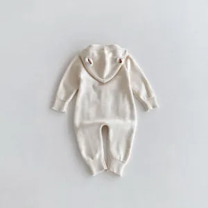 Detailed view of baby knitted hooded romper back, cute bear ears design, soft cotton knit.
