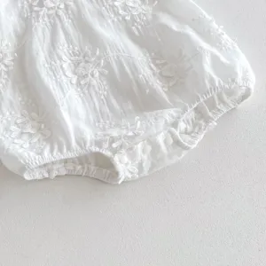 White baby girl floral embroidered romper detail view, breathable summer infant creeper.