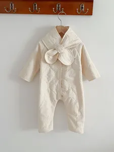 Detailed view of the baby quilted romper in off-white, featuring a cozy oversized collar design.