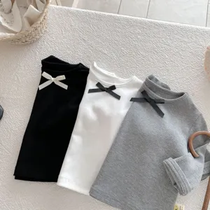 Detailed view of cute toddler girls long sleeve t-shirt, casual round neck ribbed top with bow.