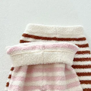 Close-up detail of soft fuzzy striped fleece baby loungewear fabric texture cozy winter