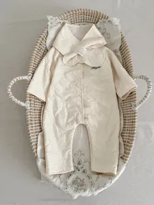 Detailed view of the cute beige fleece-lined baby winter romper with quilted design and collar.