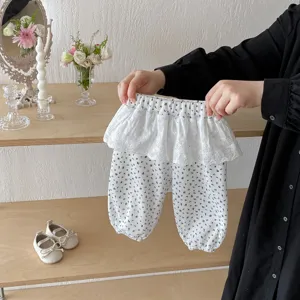 Close up detail of baby toddler floral trousers featuring cute lace ruffle waist design.