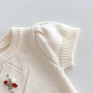 Baby knit cotton short sleeve top with delicate handmade crochet detail, soft cream color.