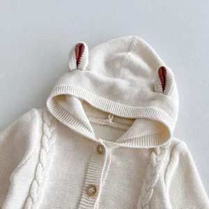 Cute baby knitted hooded sweater detail view, soft cotton yarn infant clothing with ears.