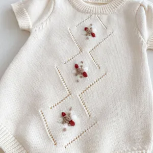 Knitted baby romper with diamond hollow-out pattern and cute embroidery, soft cotton fabric.