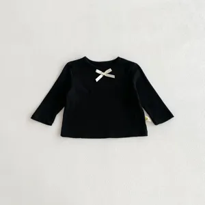 Detailed view of cute toddler girls black long sleeve t-shirt featuring sweet bow detail.