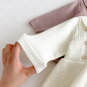 Detail view of the soft knitted baby dress cuff and textured fabric, cozy and elastic design.