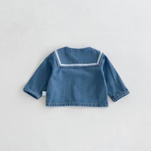 Baby denim jacket detail view showing soft blue fabric and classic white sailor collar.