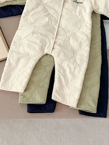 Detailed view of quilted baby winter romper featuring warm fleece lining and comfortable cotton fabric.