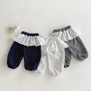 Close-up detail shot of infant floral ruffle trousers featuring lace waistband and cute design.