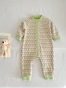 Charming knit baby romper featuring a delicate tulip pattern and soft green trim details.