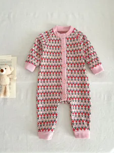 Baby knit romper featuring charming floral pattern, front buttons, and pink ribbed trim details.