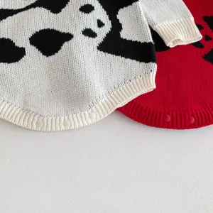 Detailed close-up view of cute infant knitted romper featuring cozy fabric and convenient snap buttons.