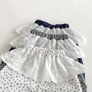 Detailed view of stacked baby girl ruffle leggings, cute floral print and lace trim details.