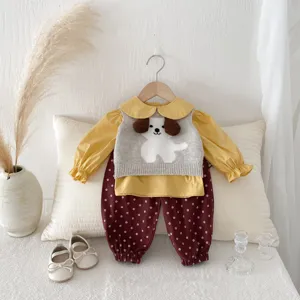 Detailed view of baby girl fall outfit, cute 3D puppy knit vest, yellow collar shirt.