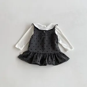 Detailed view of the cute baby girls long sleeve shirt and polka dot ruffled dress set.