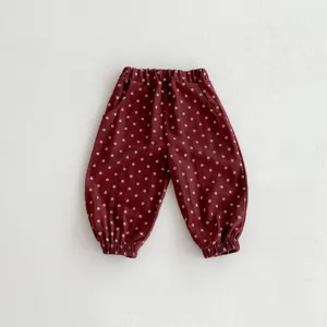 Detailed view of dark red baby cotton bloomers with cute white floral print and elastic cuffs.