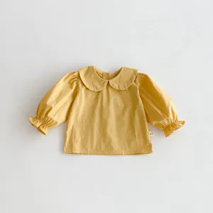 Toddler cute yellow long-sleeve cotton blouse with peter pan collar, detailed flat lay view.