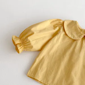Toddler girl yellow blouse detail, cute peter pan collar, puff sleeves with ruffled cuffs.