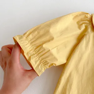 Yellow baby girl cotton short puff sleeve detail close up, cute toddler top showcase