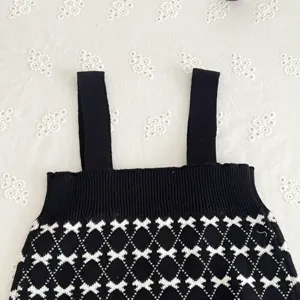 Baby girl black knit strap romper with cute white bow pattern infant autumn knitwear