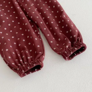 Detailed shot of toddler girls floral print sweatpants with elastic cuffs, cozy cotton material.