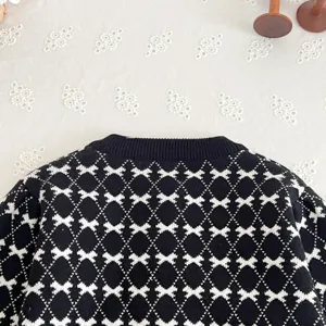 Kids black white knit cardigan, cute geometric bow pattern, soft autumn toddler sweater.