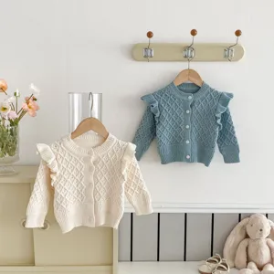 Infant baby knitted cardigan sweater with diamond pattern and cute flying sleeves, detail view.