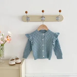 Close-up detail of the blue infant knit cardigan featuring diamond jacquard and cute ruffle sleeves.