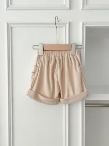 Corduroy baby shorts detail view, featuring elastic waist and cute rolled hem design.
