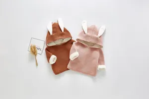 Detailed view of cozy baby knit sweater with cute rabbit ears and soft fleece lining.