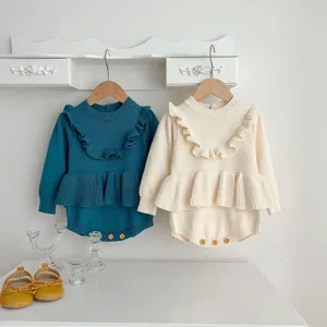 Infant baby girl knit romper detail showing cute ruffle collar, long sleeves and wooden button closure.