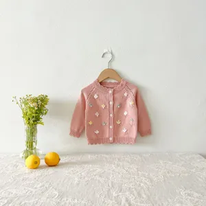 Infant pink knit cardigan detail, handmade floral embroidery, baby girl cotton sweater.